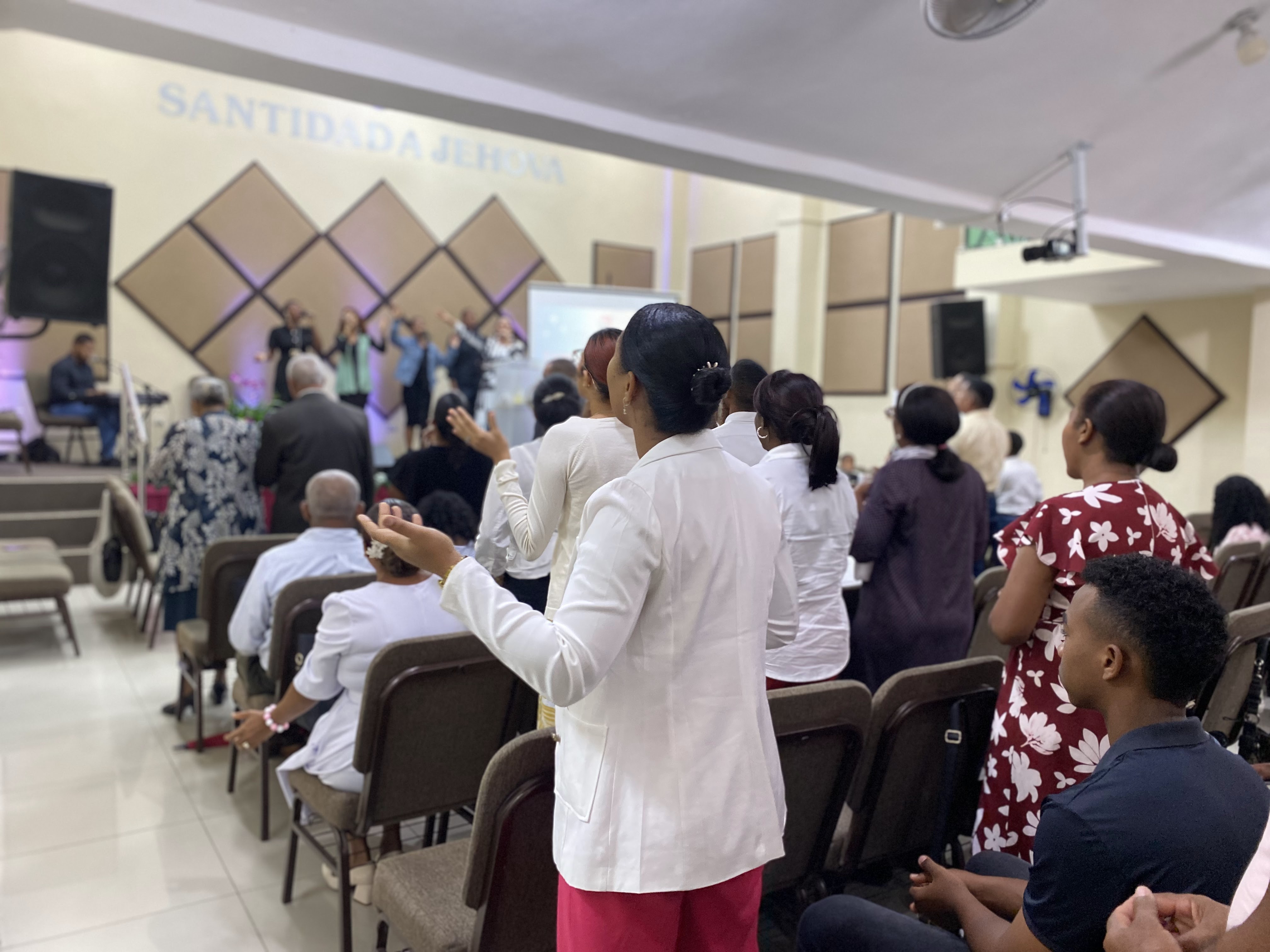 Diverse group of people smiling and talking in a church lobby